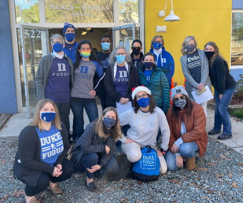 Duke Fuqua staff and students take a group photo outside the Meals on Wheels Durham building.