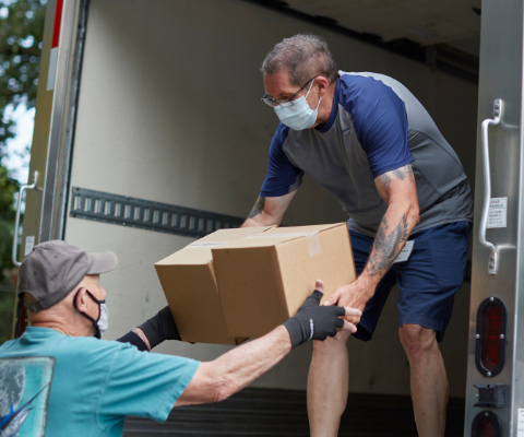 Volunteers unloading boxes from food truck